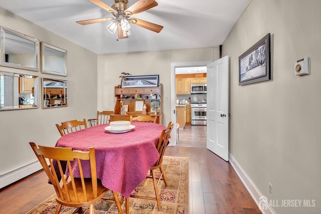 dining space with a baseboard heating unit, hardwood / wood-style floors, and ceiling fan