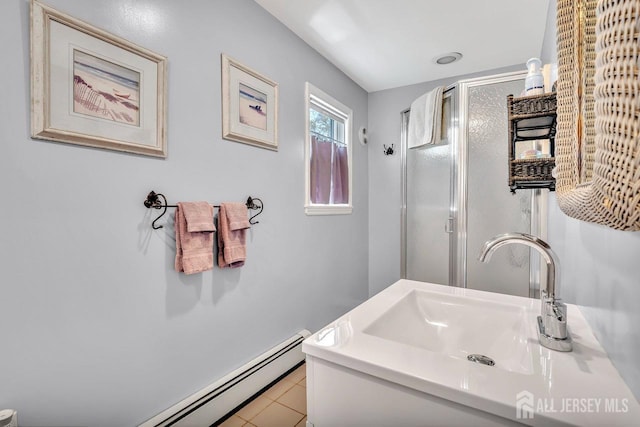 bathroom featuring a stall shower, tile patterned flooring, a sink, and a baseboard radiator