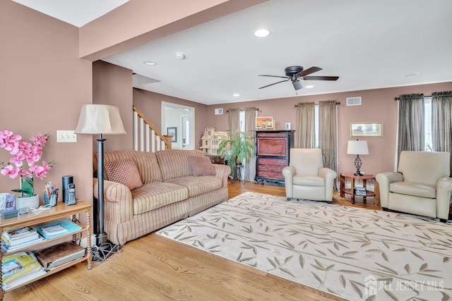 living area with wood finished floors, visible vents, ceiling fan, and recessed lighting