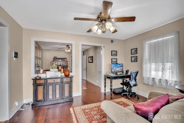 home office featuring dark wood finished floors, visible vents, ceiling fan, and baseboards