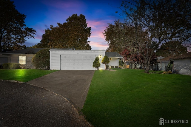 view of front facade featuring a yard and a garage