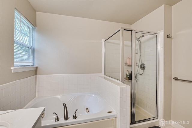 bathroom featuring vanity and plus walk in shower