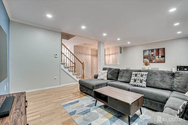 living room with crown molding and light wood-type flooring