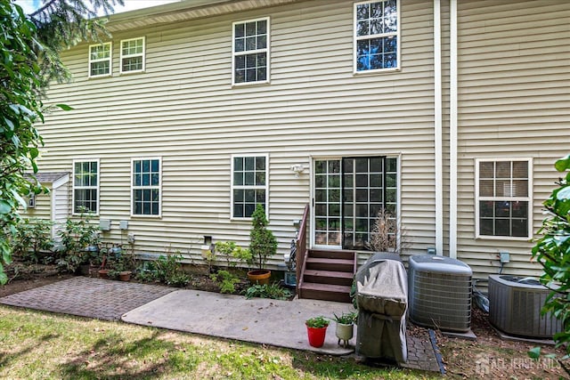 rear view of house featuring central AC and a patio