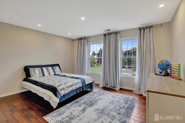 bedroom with dark hardwood / wood-style flooring