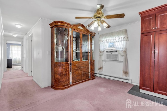 spare room featuring a baseboard radiator, light colored carpet, ceiling fan, ornamental molding, and cooling unit