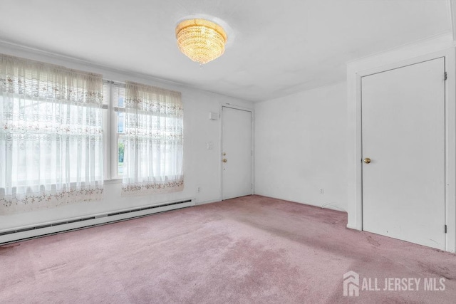 carpeted spare room featuring a baseboard heating unit