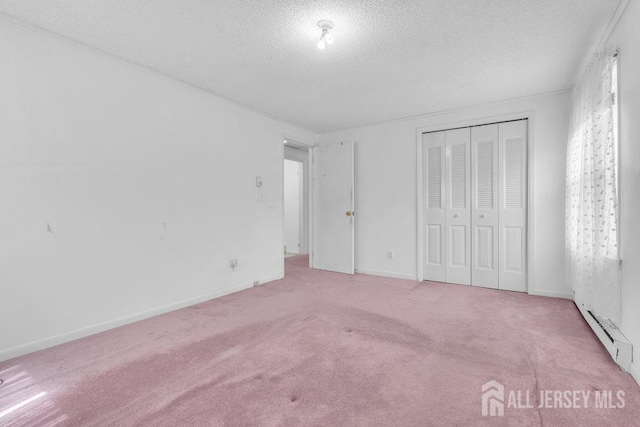 unfurnished bedroom featuring a textured ceiling, carpet flooring, a closet, and baseboards