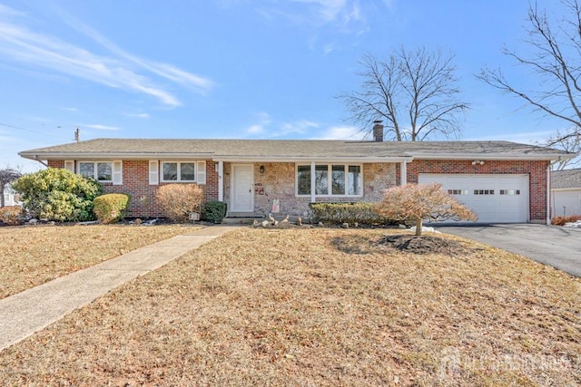 single story home featuring a garage and a front yard