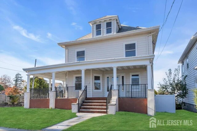 view of front of property with covered porch and a front lawn