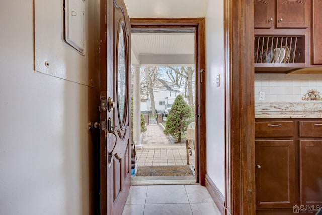 doorway with light tile patterned flooring