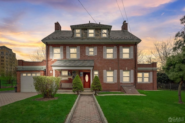 view of front of property featuring brick siding, fence, a chimney, decorative driveway, and a yard