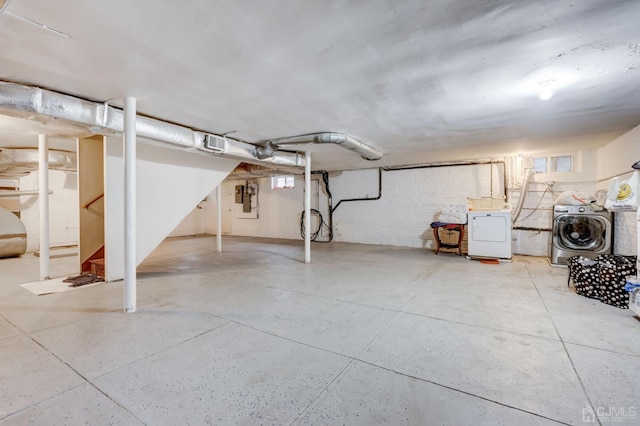 unfinished basement with electric panel, independent washer and dryer, and stairs