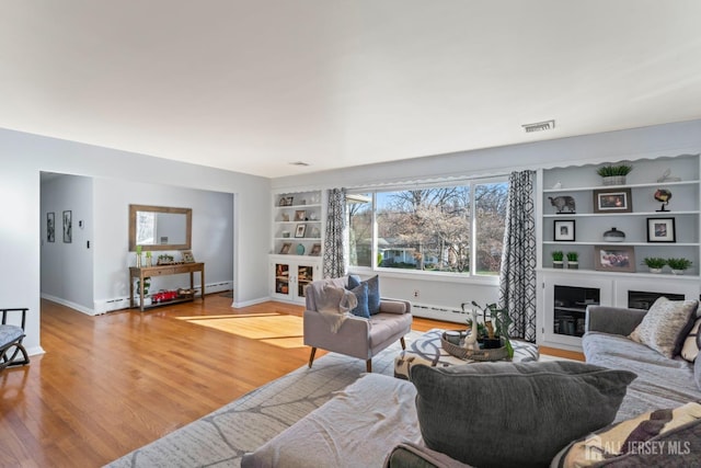 8 Martha Blvd, Sayreville, NJ 08879 - living room featuring built in shelves, baseboards, wood finished floors, and healthy amount of natural light