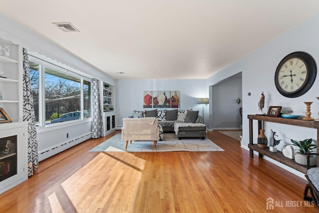 8 Martha Blvd, Sayreville, NJ 08879 - living room featuring a baseboard heating unit and wood finished floors