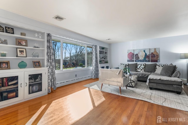 8 Martha Blvd, Sayreville, NJ 08879 - living area featuring a baseboard radiator and wood finished floors