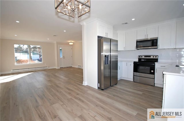 kitchen with stainless steel appliances, a baseboard radiator, light hardwood / wood-style floors, and white cabinetry