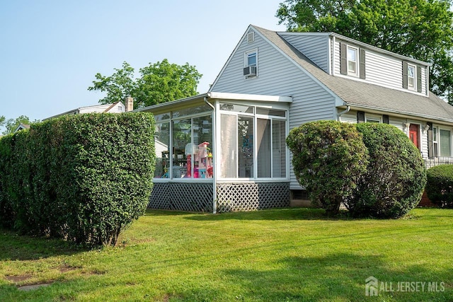 1457 George St Unit 61, Plainfield, NJ 07062 - rear view of house with a sunroom, a lawn, and roof with shingles