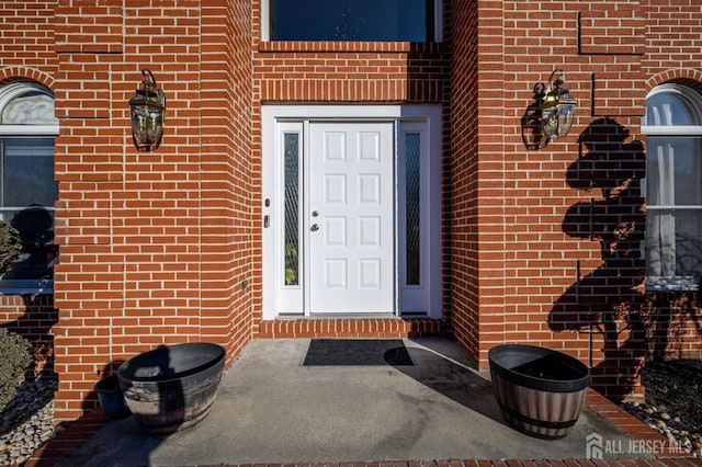 entrance to property with brick siding