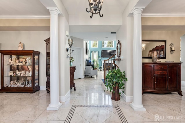 foyer with crown molding and decorative columns