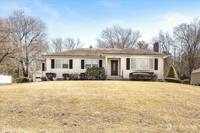 single story home featuring a chimney and a front lawn