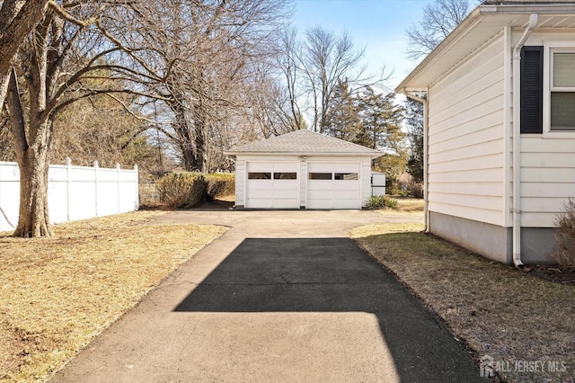 view of yard with a garage, an outdoor structure, and fence