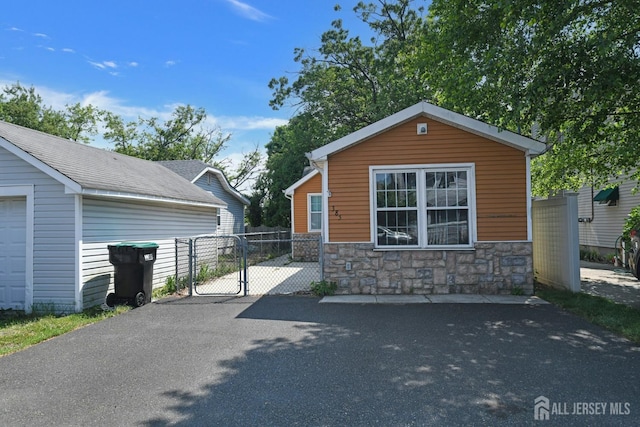 385 Shoreland Cir, Old Bridge, NJ 08879 - view of front of house featuring stone siding and a gate