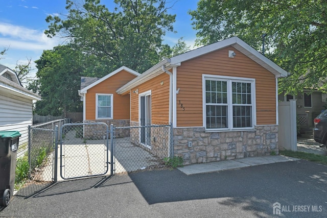 385 Shoreland Cir, Old Bridge, NJ 08879 - view of front of home with stone siding and a gate