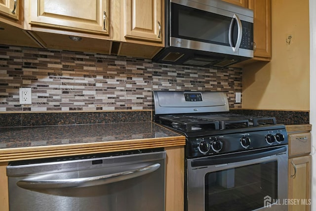 385 Shoreland Cir, Old Bridge, NJ 08879 - kitchen with appliances with stainless steel finishes, dark countertops, and decorative backsplash