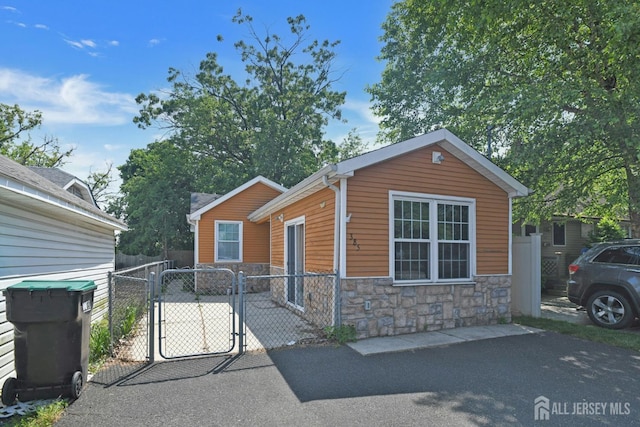 385 Shoreland Cir, Old Bridge, NJ 08879 - view of front of property with stone siding and a gate