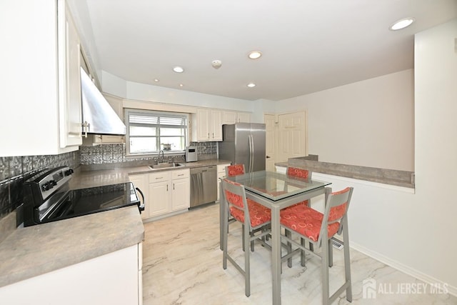 kitchen featuring marble finish floor, stainless steel appliances, backsplash, white cabinetry, and a sink