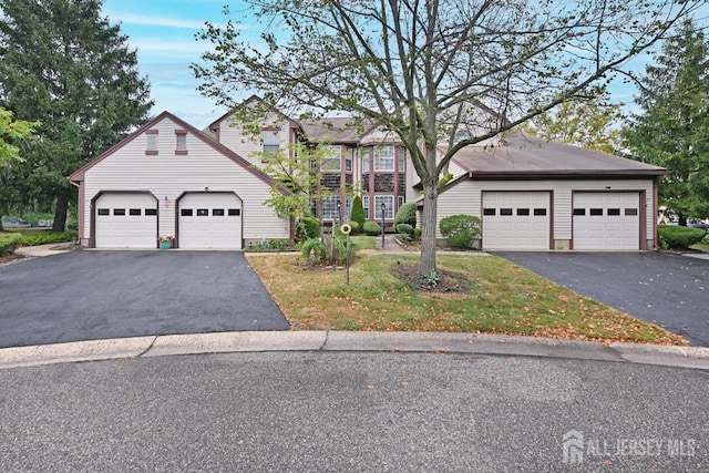 colonial home with aphalt driveway
