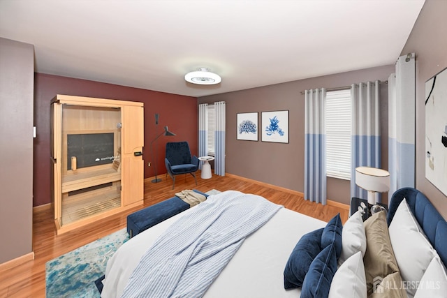 bedroom with light wood-style floors and baseboards
