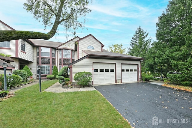 view of front of home with driveway, a garage, and a front lawn