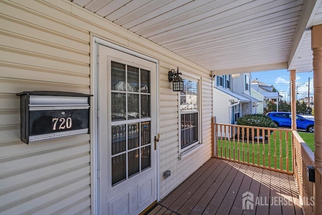 wooden terrace featuring covered porch