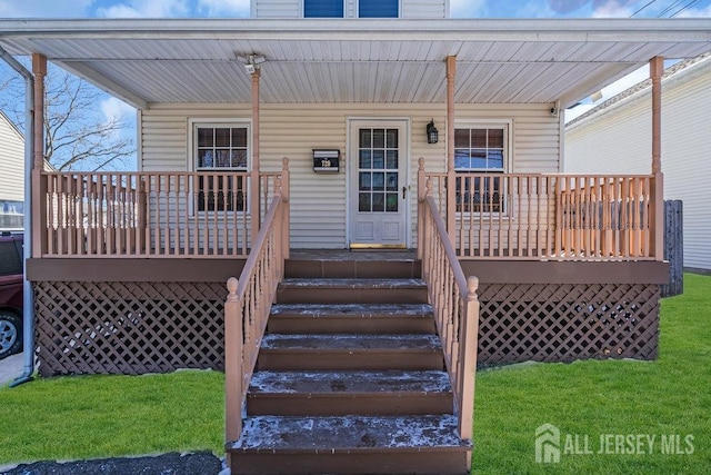 view of exterior entry with covered porch