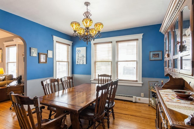 177 Hillside Ave, South River, NJ 08882 - dining area with arched walkways, a baseboard radiator, light wood-style floors, and a chandelier