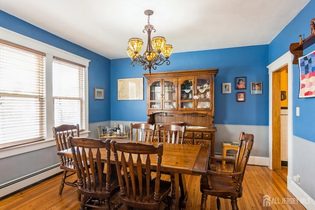177 Hillside Ave, South River, NJ 08882 - dining space with a baseboard radiator, a chandelier, healthy amount of natural light, and hardwood / wood-style flooring