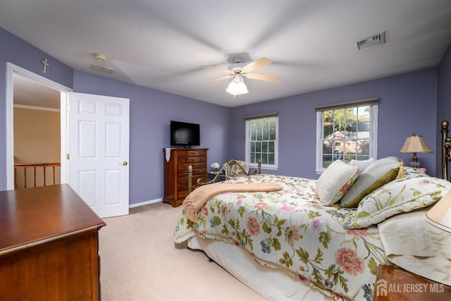 carpeted bedroom with baseboards, visible vents, and a ceiling fan