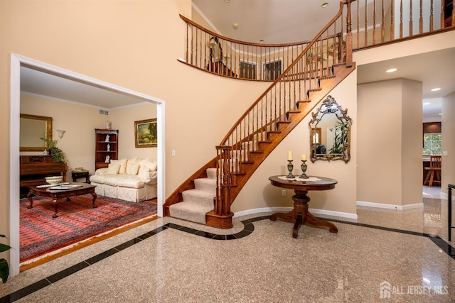 stairs with a high ceiling, granite finish floor, recessed lighting, and baseboards