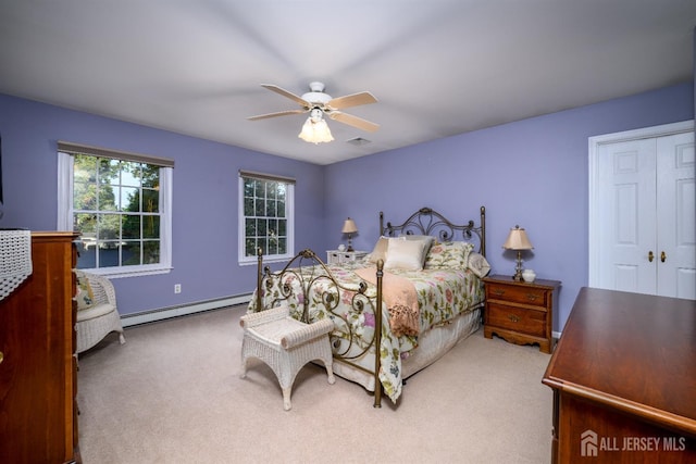 carpeted bedroom with a baseboard heating unit, visible vents, and ceiling fan