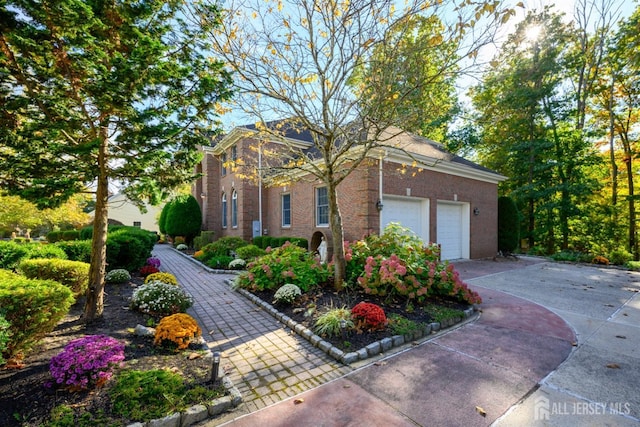 exterior space with driveway, an attached garage, and brick siding