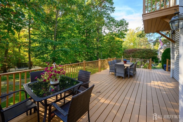 wooden terrace with outdoor dining space