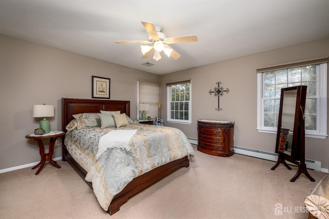 bedroom featuring baseboard heating, light colored carpet, ceiling fan, and baseboards