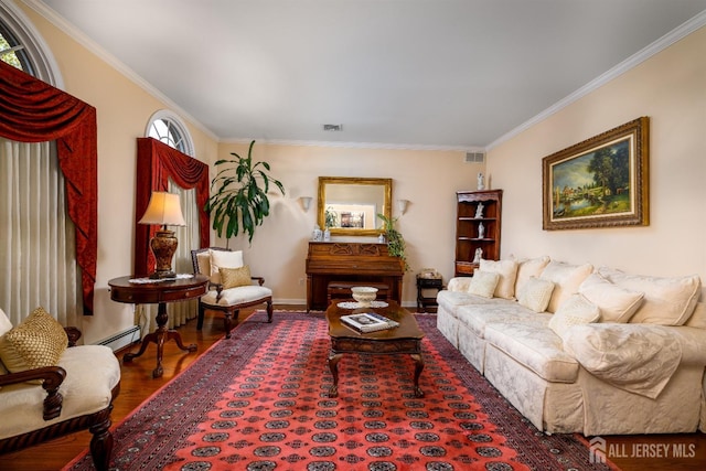 living area with visible vents, a baseboard heating unit, wood finished floors, and ornamental molding