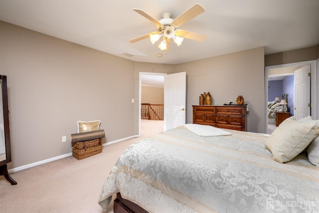 carpeted bedroom with visible vents, a ceiling fan, and baseboards