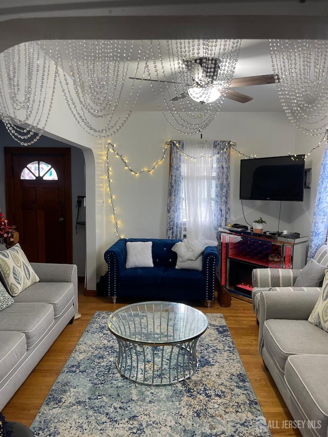 living room with a chandelier and wood-type flooring