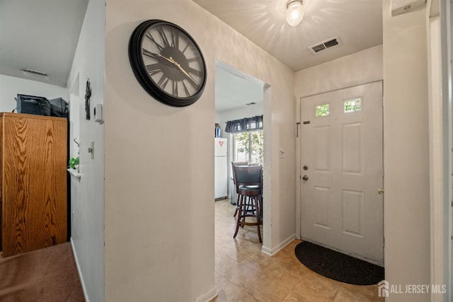 1103 Schmidt Ln, North Brunswick, NJ 08902 - entryway featuring light tile patterned floors and baseboards