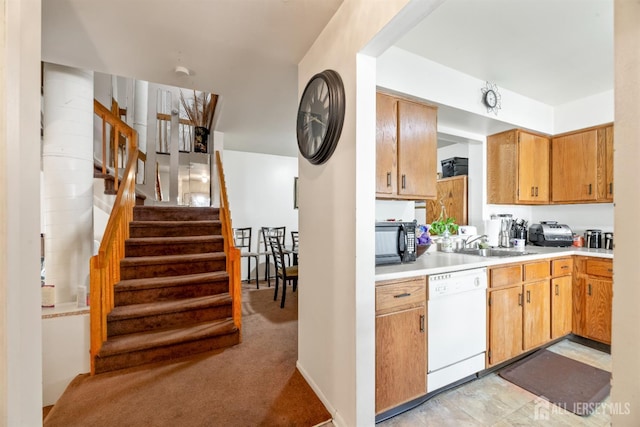 1103 Schmidt Ln, North Brunswick, NJ 08902 - kitchen featuring white dishwasher, black microwave, light countertops, and light carpet