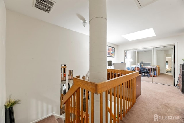 1103 Schmidt Ln, North Brunswick, NJ 08902 - corridor featuring carpet flooring, an upstairs landing, a desk, and a skylight